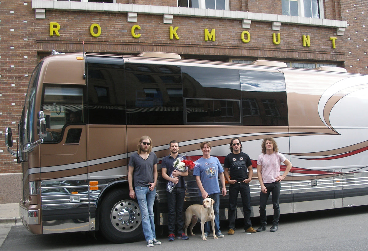 The Killers band posing outside Rockmount Ranch Wear flagship store on Wazee Street in Denver with Steve Weil